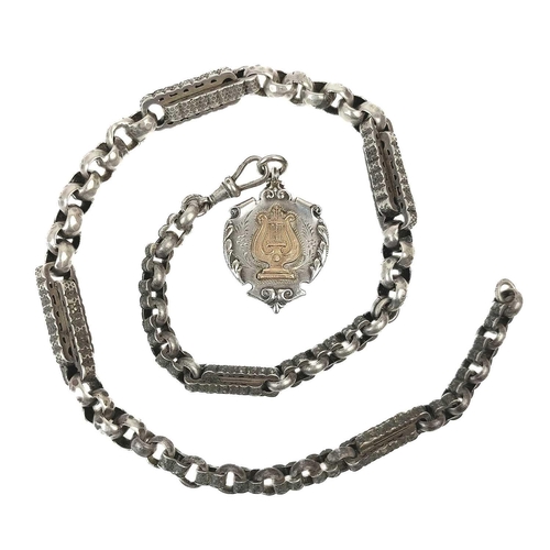 58 - A 19th century white metal fancy link Albert watch chain. With rose gold metal shield fob, length 51... 