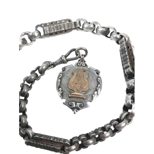 58 - A 19th century white metal fancy link Albert watch chain. With rose gold metal shield fob, length 51... 