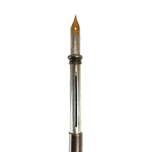 59 - An early 20th century silver propelling double gold nib pen and pencil. The nib stamped 14k, the bar... 