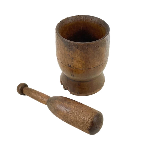 103 - A treen pestle and mortar. Circa 1860, on a turned, slightly flared base, height 18cm, diameter 14.5... 