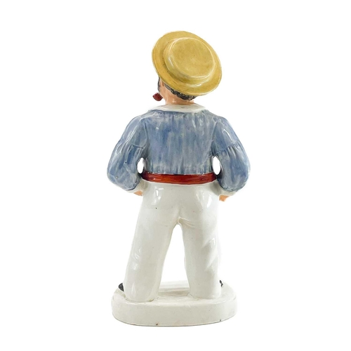 104 - A Victorian Staffordshire figure of a sailor. The portly figure modelled standing and smoking a pipe... 