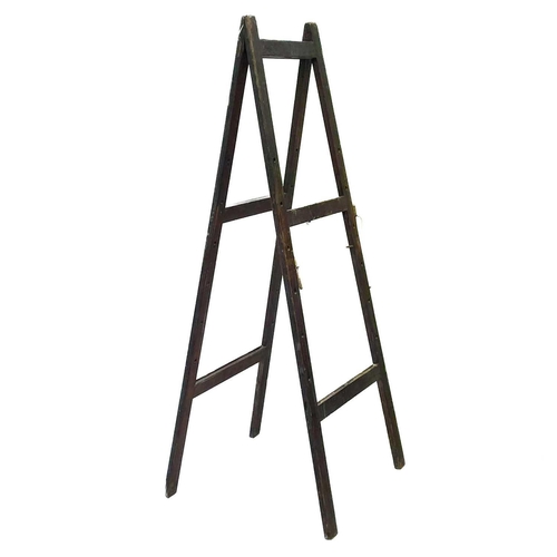 107 - A folding easel. With applied Educational supplies label, height 183cm, maximum width 71cm.