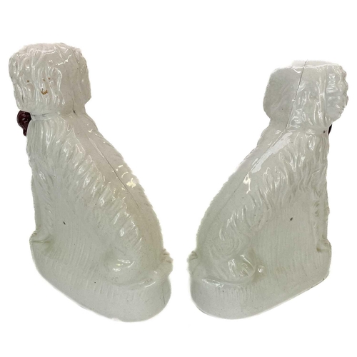 113 - A pair of Victorian Staffordshire figures of oversized spaniels. Seated beside diminutive figures wi... 