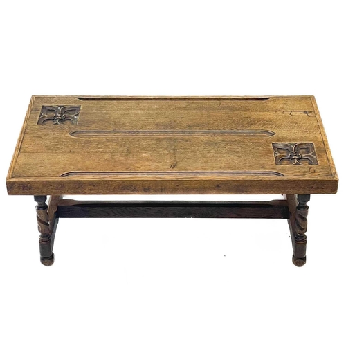 115 - An oak coffee table, the top constructed from two pew ends. With incised quatrefoils, on twist legs,... 