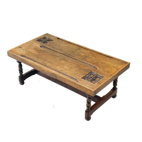 115 - An oak coffee table, the top constructed from two pew ends. With incised quatrefoils, on twist legs,... 