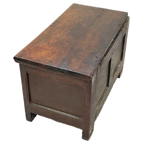 116 - An 18th century small oak coffer. Fitted a candle box, with a stop fluted frieze and two panel front... 