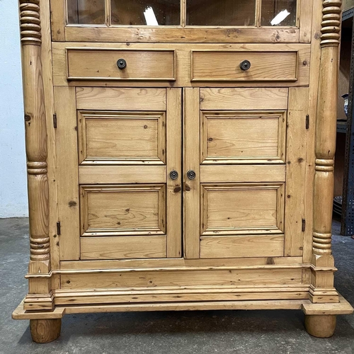 117 - A 19th century Cornish pine standing corner cupboard. With an astragal glazed door above two short d... 