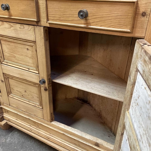 117 - A 19th century Cornish pine standing corner cupboard. With an astragal glazed door above two short d... 