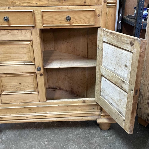 117 - A 19th century Cornish pine standing corner cupboard. With an astragal glazed door above two short d... 