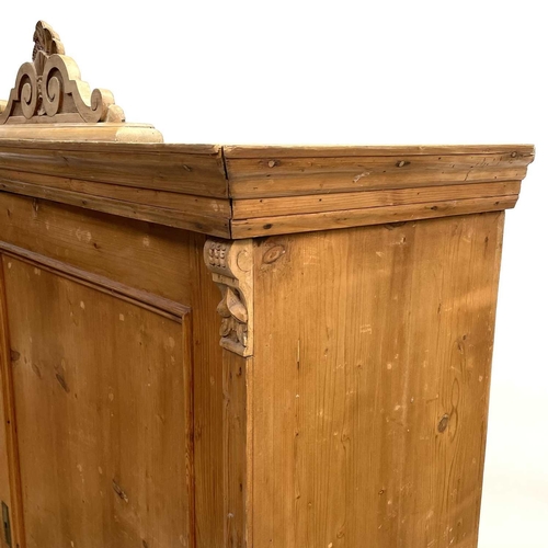 117 - A 19th century Cornish pine standing corner cupboard. With an astragal glazed door above two short d... 