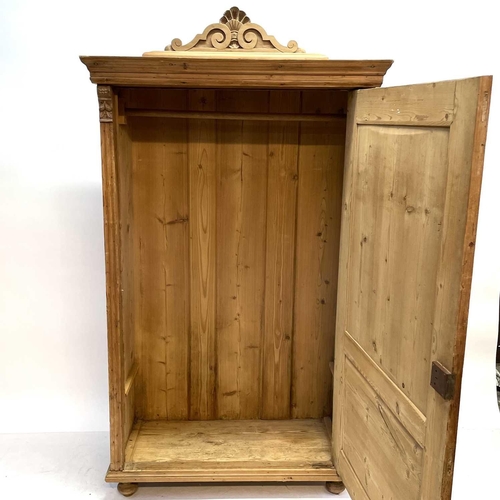 117 - A 19th century Cornish pine standing corner cupboard. With an astragal glazed door above two short d... 