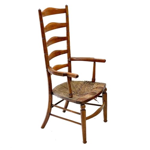 121 - A Victorian beech framed ladderback kitchen armchair. With a woven seagrass seat on turned legs, wit... 