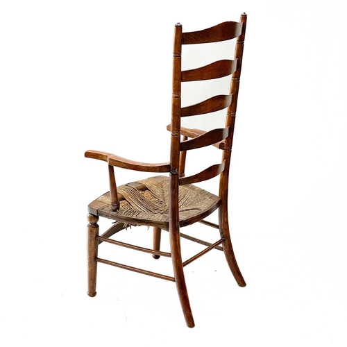 121 - A Victorian beech framed ladderback kitchen armchair. With a woven seagrass seat on turned legs, wit... 