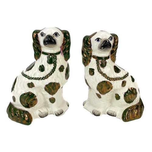 125 - A pair of Victorian Staffordshire green and copper lustre spaniels. Height 25cm, together with anoth... 