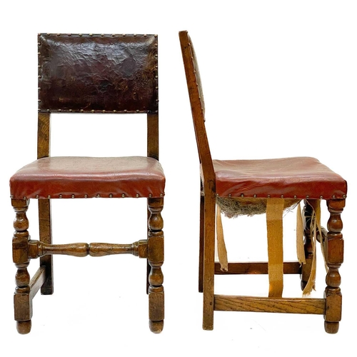 129 - A pair of oak and leather Cromwellian style chairs. With padded backs and seats on turned square sec... 