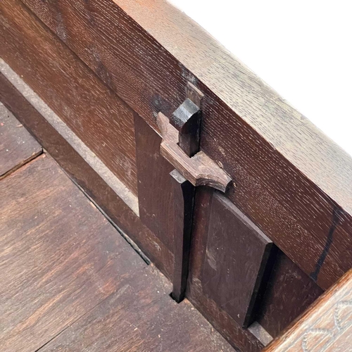 130 - An oak joined small mule chest. Early 18th century, the interior fitted a candle box, the three pane... 