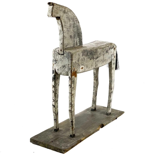 131 - A naive painted toy horse. Late 19th/early 20th century, raised on a plank base, height 55cm, width ... 