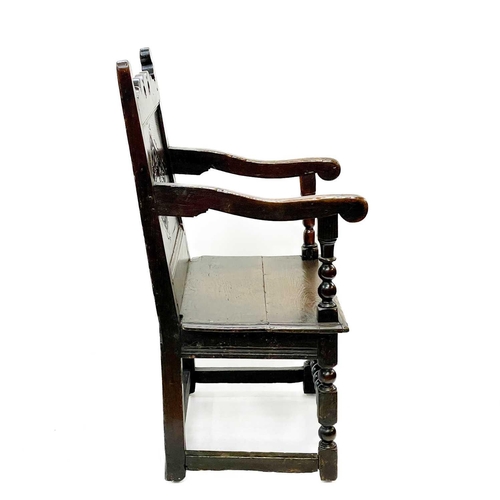 132 - A 17th century North Country bobbin Wainscot chair. With a shaped top rail, central carved lozenge a... 