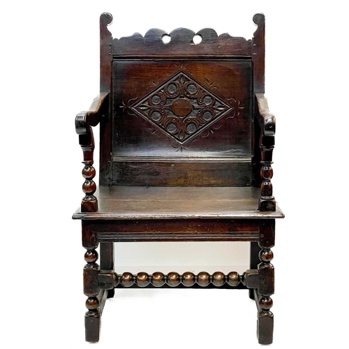 132 - A 17th century North Country bobbin Wainscot chair. With a shaped top rail, central carved lozenge a... 