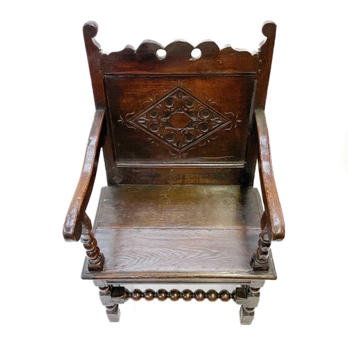 132 - A 17th century North Country bobbin Wainscot chair. With a shaped top rail, central carved lozenge a... 