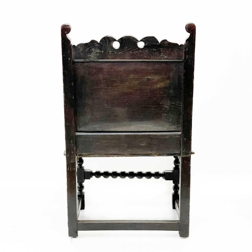 132 - A 17th century North Country bobbin Wainscot chair. With a shaped top rail, central carved lozenge a... 