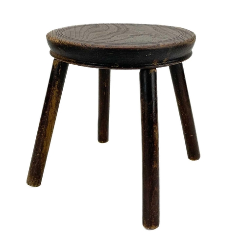 133 - An elm top small circular stool. 19th century, raised on four turned beech legs, height 26.5cm, diam... 