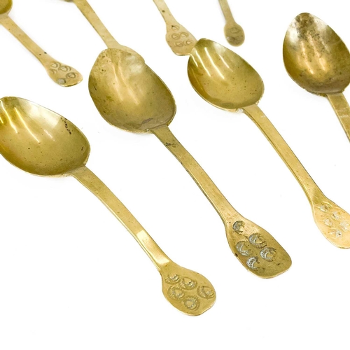 136 - A group of eight French brass spoons. 19th century, the finials variously punch struck with acorns, ... 