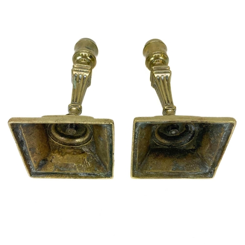 138 - A pair of Georgian brass candlesticks. With square fluted columns on square bases, height 16.5cm.Som... 