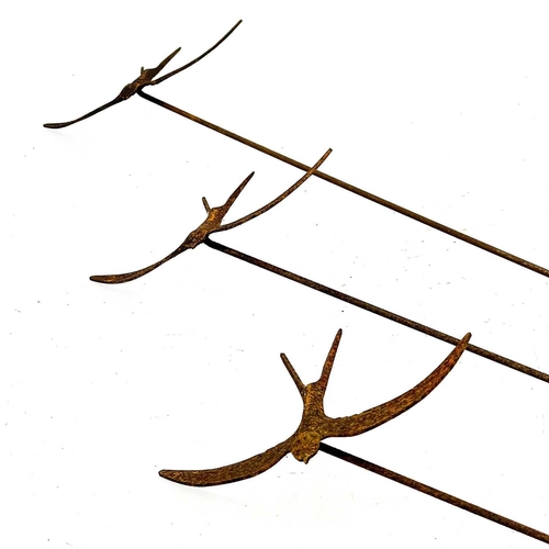 146 - Three wrought iron swallow garden ornaments. Height 161cm.The three swallows are in a rusted but sta... 