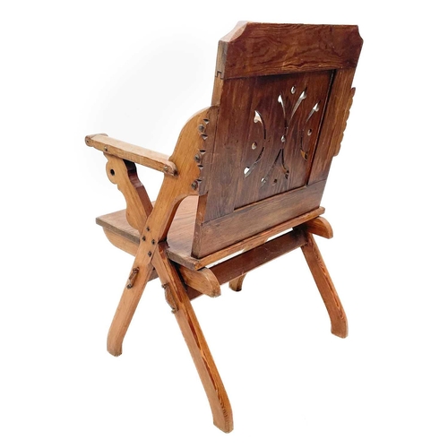 154 - A late Victorian pitch pine Gothic side chair. With pierced panel back, solid seat and X shape suppo... 