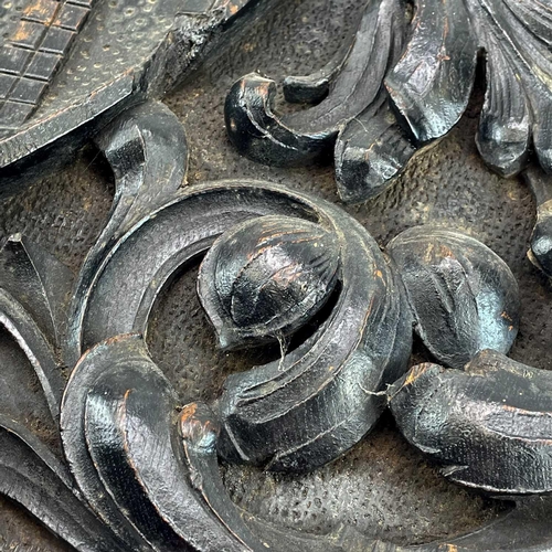 155 - A carved oak heraldic panel. 19th century, the central shield with a lion rampant, within scrolling ... 