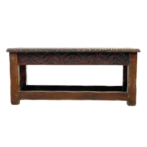 161 - A late Victorian carved oak long stool. In the 17th century style, the rectangular top with carved e... 