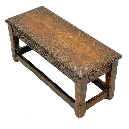 161 - A late Victorian carved oak long stool. In the 17th century style, the rectangular top with carved e... 