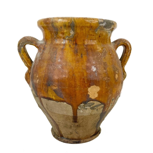 162 - A 19th century French pottery twin handled confit pot. With mustard glaze, height 21cm.