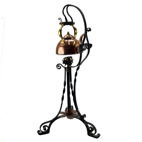 167 - A Victorian copper and wrought iron kettle and stand. In the Aesthetic taste, with scrolled and peta... 