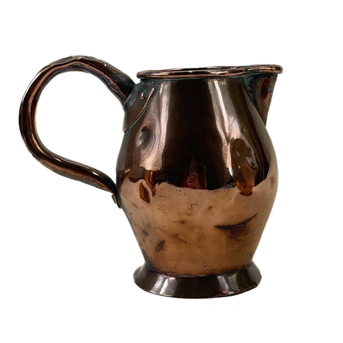 168 - A late George III copper ale jug. Of baluster form, height 19cm, together with a matching smaller ju... 