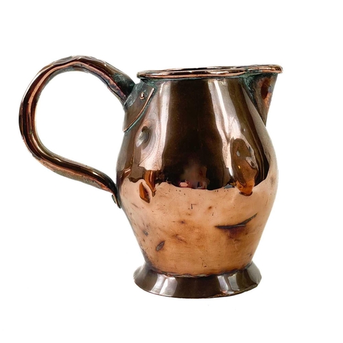 168 - A late George III copper ale jug. Of baluster form, height 19cm, together with a matching smaller ju... 