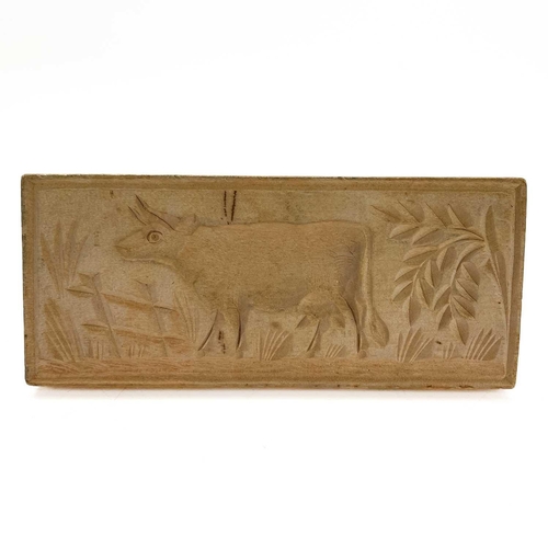 174 - A late Victorian treen butter mould, carved with a cow. Width 18cm, together with a glass table top ... 