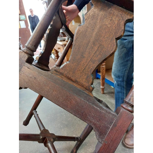 183 - A George II oak corner tub chair. With bow backrest, shaped splats two recessed holders on cabriole ... 