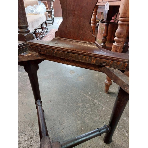 183 - A George II oak corner tub chair. With bow backrest, shaped splats two recessed holders on cabriole ... 