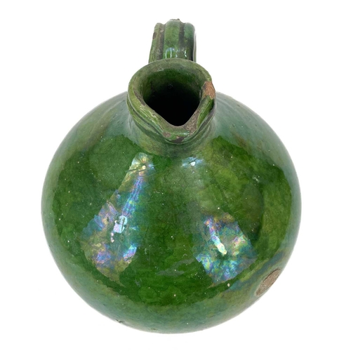 188 - A 19th century French pottery oil jug. With rich green glaze, height 24cm.Chip to rim, some wear and... 