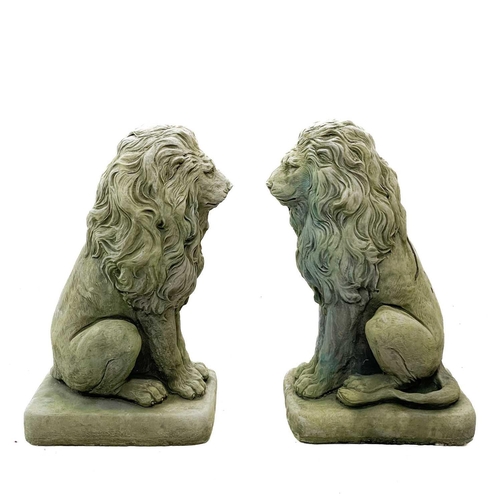 190 - A pair of reconstituted stone lion figures. The lions raised on a matched concrete base, overall hei... 