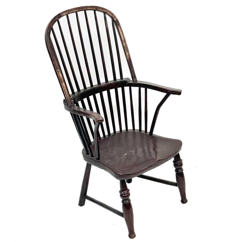 193 - A stained beech kitchen Windsor armchair. 19th century, with a spindle back, on turned legs, height ... 