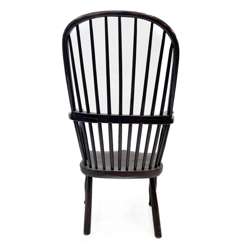 193 - A stained beech kitchen Windsor armchair. 19th century, with a spindle back, on turned legs, height ... 