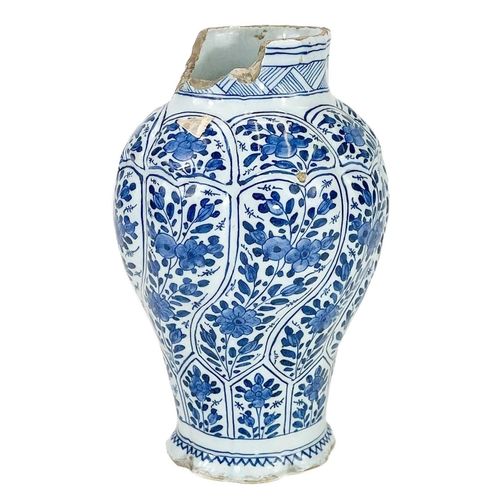 196 - A Delft blue and white baluster vase in the Kangxi style. Moulded wrythen form, height 19cm.