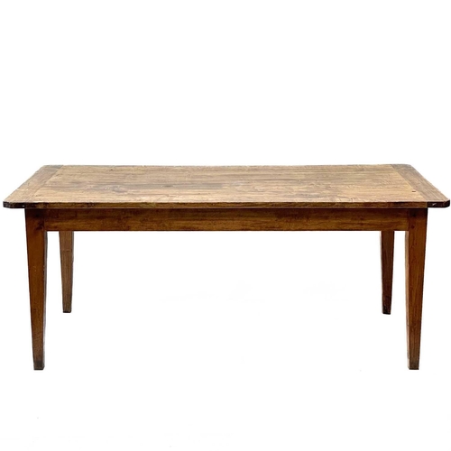 197 - A French farmhouse poplar and fruitwood dining table. 19th century, fitted a single frieze drawer, r... 