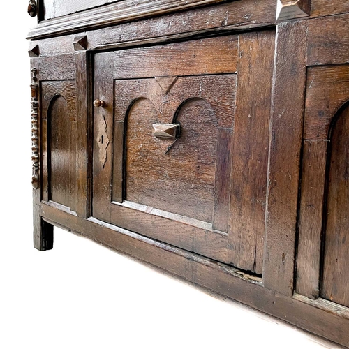 198 - A late 17th century livery cupboard. In two sections with long single drawer above two cupboard door... 