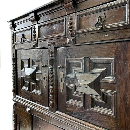 198 - A late 17th century livery cupboard. In two sections with long single drawer above two cupboard door... 