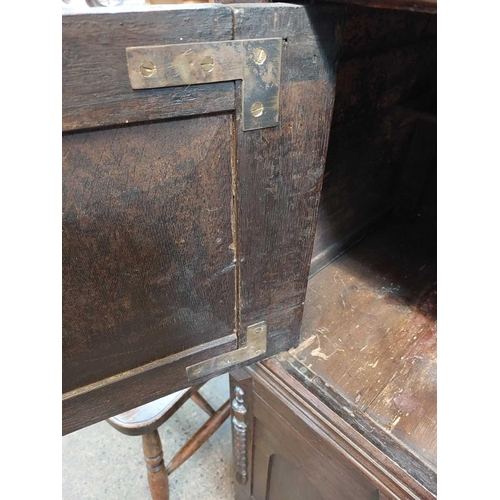 198 - A late 17th century livery cupboard. In two sections with long single drawer above two cupboard door... 