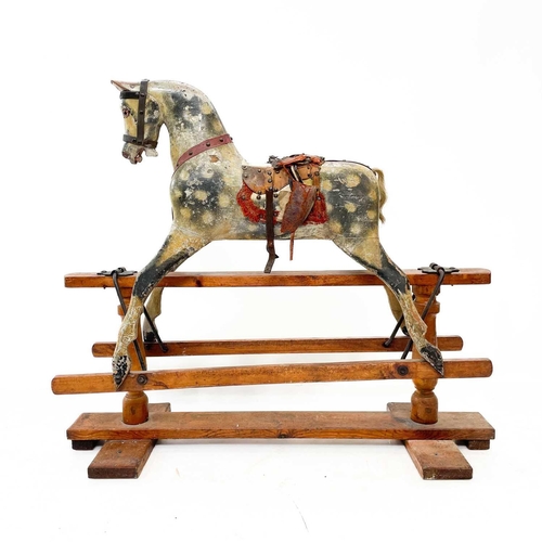 2 - A Victorian dapple grey rocking horse. Raised on a pine base, with baluster supports, and iron rocke... 